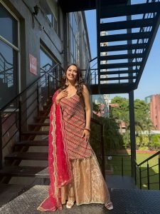 Eshanya Maheshwari red lehenga balcony natural sunlight portrait