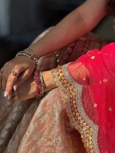 Eshanya Maheshwari twirling in red lehenga on sunny balcony