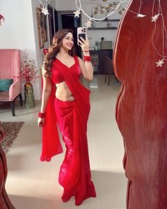 Natural sunlight highlighting Eshanya Maheshwari's red saree in garden