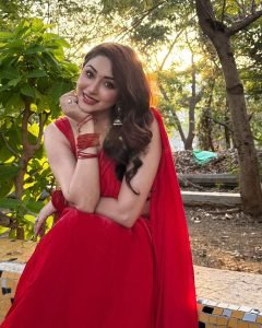 Natural sunlight highlighting Eshanya Maheshwari's red saree in garden