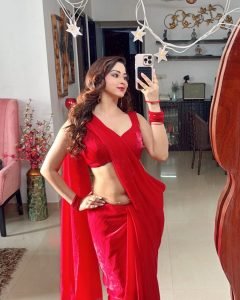 Natural sunlight highlighting Eshanya Maheshwari's red saree in garden