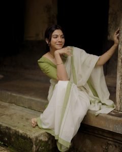 Madonna Sebastian soft smile in white saree with green border