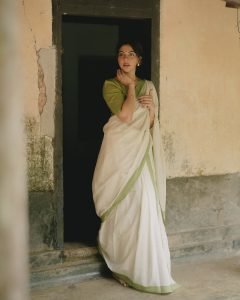 Natural portrait of Madonna Sebastian in white green bordered saree