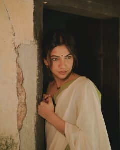 Madonna Sebastian gentle expression wearing elegant white saree