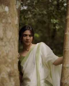 Madonna Sebastian gentle expression wearing elegant white saree