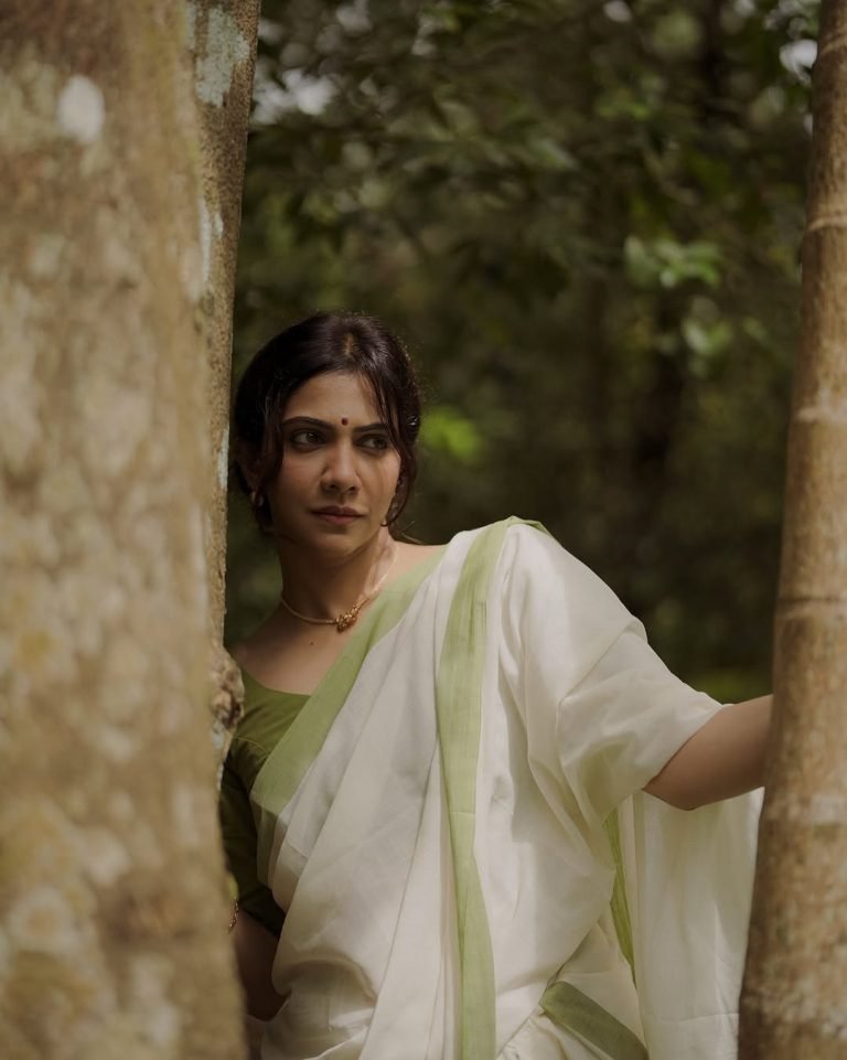 Madonna Sebastian gentle expression wearing elegant white saree