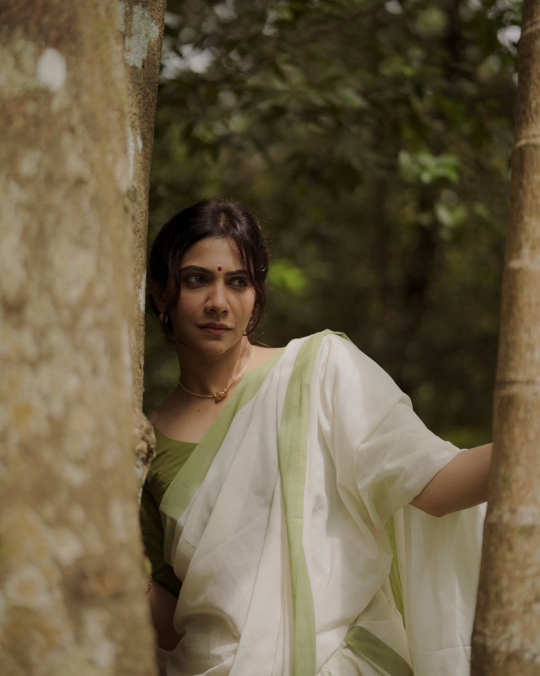 Madonna Sebastian gentle expression wearing elegant white saree