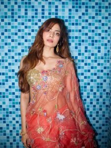 Malavika Mohanan coral floral saree against colorful mosaic wall backdrop