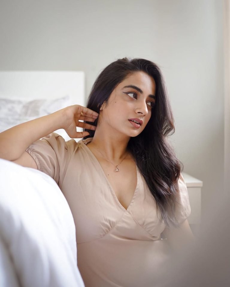 Namitha Pramod graceful pose in neutral beige open back dress