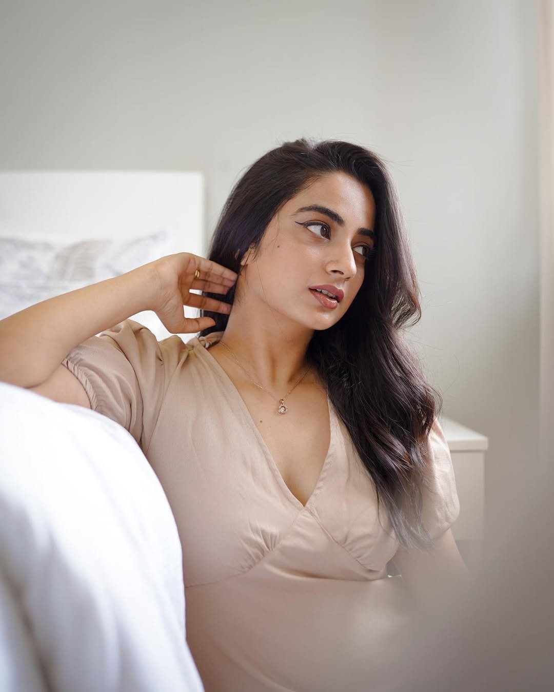 Namitha Pramod graceful pose in neutral beige open back dress