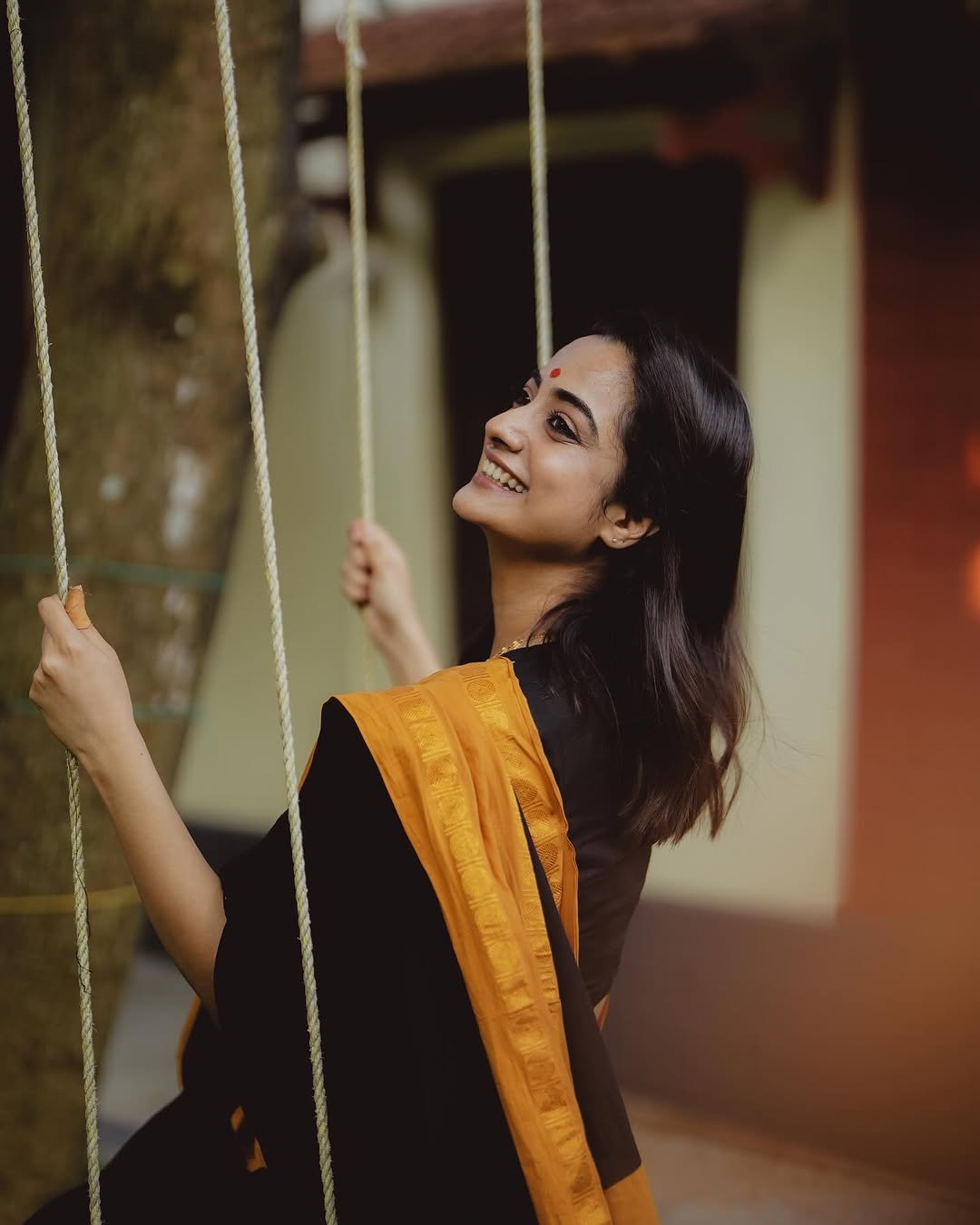 Namitha Pramod black saree mustard border swing glance Photos (1)