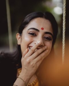 Namitha Pramod swinging in black saree with bright mustard border