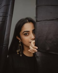 Namitha Pramod dramatic pose in black sheer layered lehenga