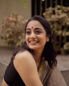 Namitha Pramod intense gaze closeup wearing classic black saree