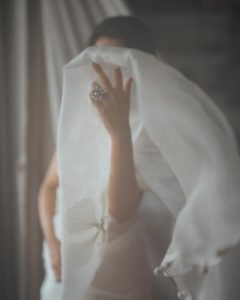 Namitha Pramod relaxed pose in ivory saree comfortable room