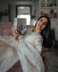 Namitha Pramod relaxed pose in ivory saree comfortable room