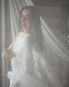 Namitha Pramod relaxed pose in ivory saree comfortable room