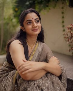 Detailed shot of Namitha Pramod black saree fabric and jewelry