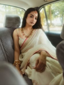 Namitha Pramod sophisticated pose in car cabin ivory saree look