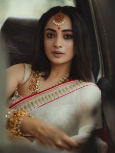 Rose-gold jewelry details on Namitha Pramod elegant ivory saree