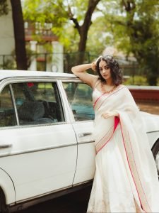 Namitha Pramod sophisticated pose in car cabin ivory saree look
