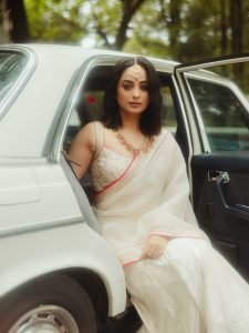 Namitha Pramod ivory saree with rose-gold jewelry in car cabin