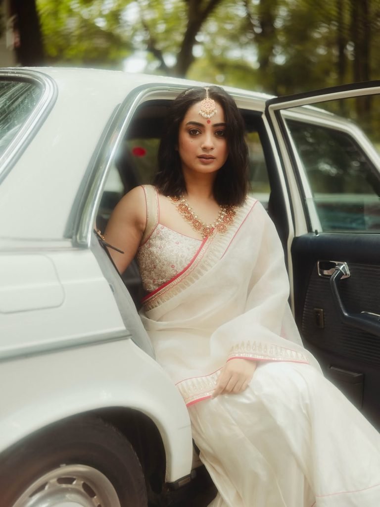 Namitha Pramod ivory saree with rose-gold jewelry in car cabin