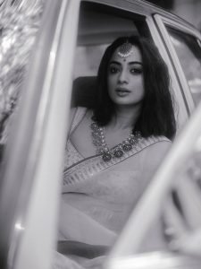 Namitha Pramod sophisticated pose in car cabin ivory saree look