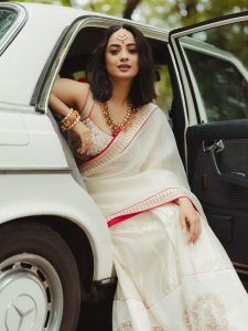 Namitha Pramod sophisticated pose in car cabin ivory saree look