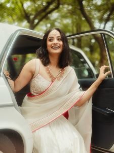 Namitha Pramod sophisticated pose in car cabin ivory saree look