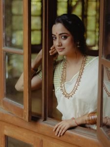 Namitha Pramod gentle smile in white saree with fresh gajra