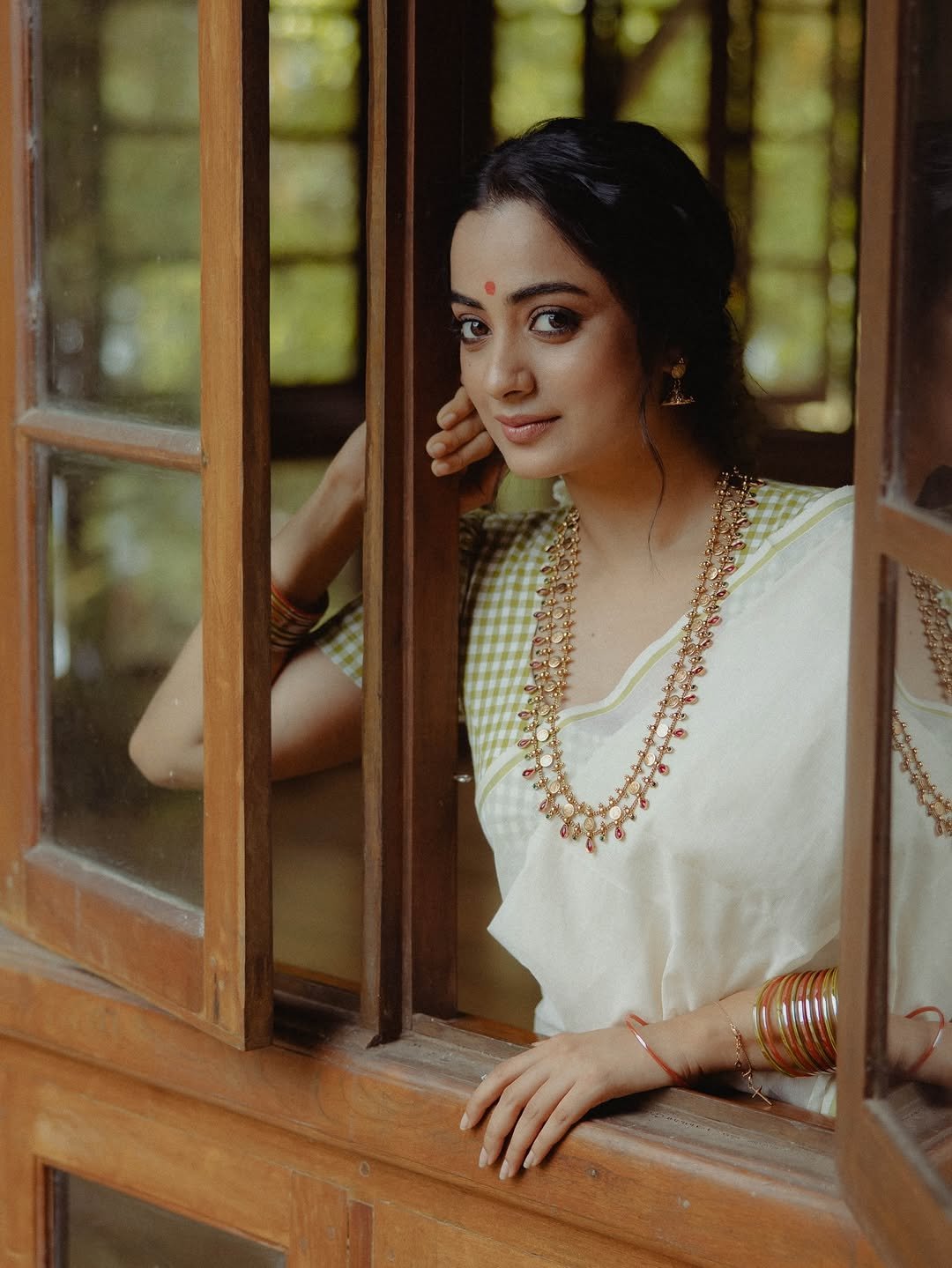 Namitha Pramod jasmine gajra white saree window-light smile Photoshoot (11)