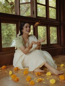 Namitha Pramod white saree with jasmine gajra in window light