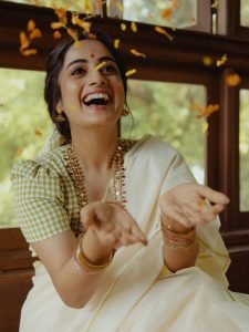 Namitha Pramod white saree with jasmine gajra in window light