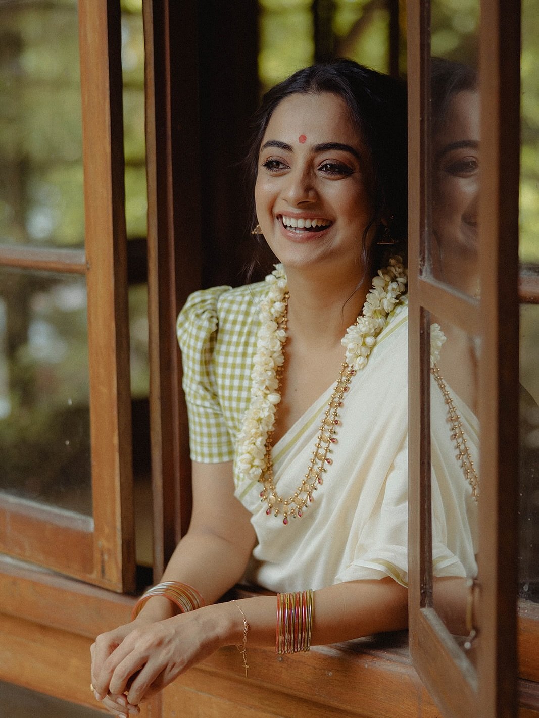 Namitha Pramod jasmine gajra white saree window-light smile Photoshoot (2)