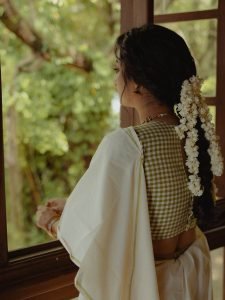 Namitha Pramod gentle smile in white saree with fresh gajra