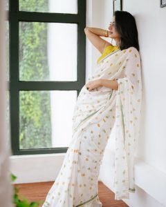 Garden flowers complementing Namitha Pramod lemon blouse saree look