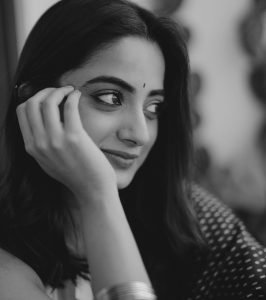 Elegant glow on Namitha Pramod in deep navy colored saree