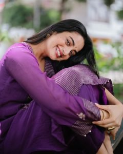 Garden bench setting with Namitha Pramod vibrant purple outfit
