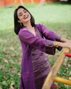 Garden bench setting with Namitha Pramod vibrant purple outfit