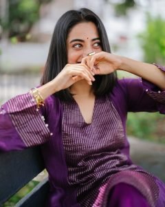 Garden bench setting with Namitha Pramod vibrant purple outfit
