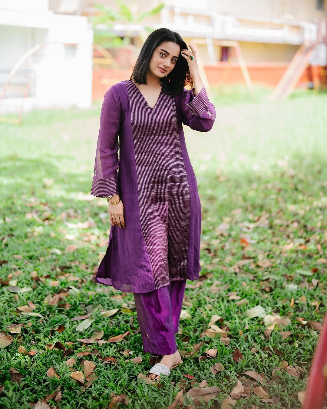 Namitha Pramod purple pleated suit garden bench radiant smile Photos (17)