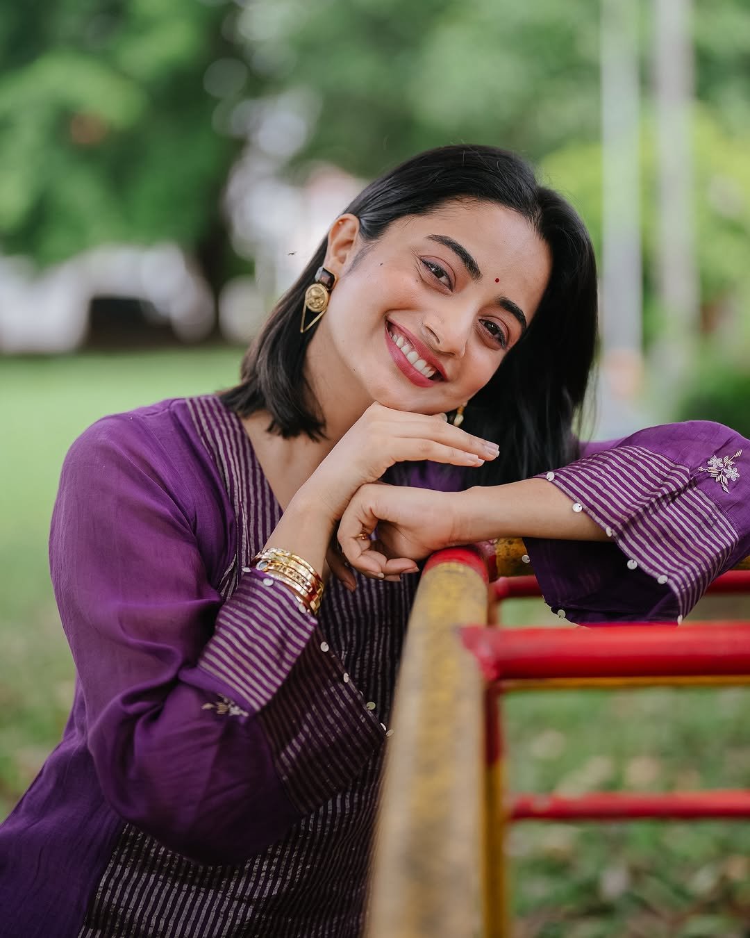 Namitha Pramod purple pleated suit garden bench radiant smile Photos (3)