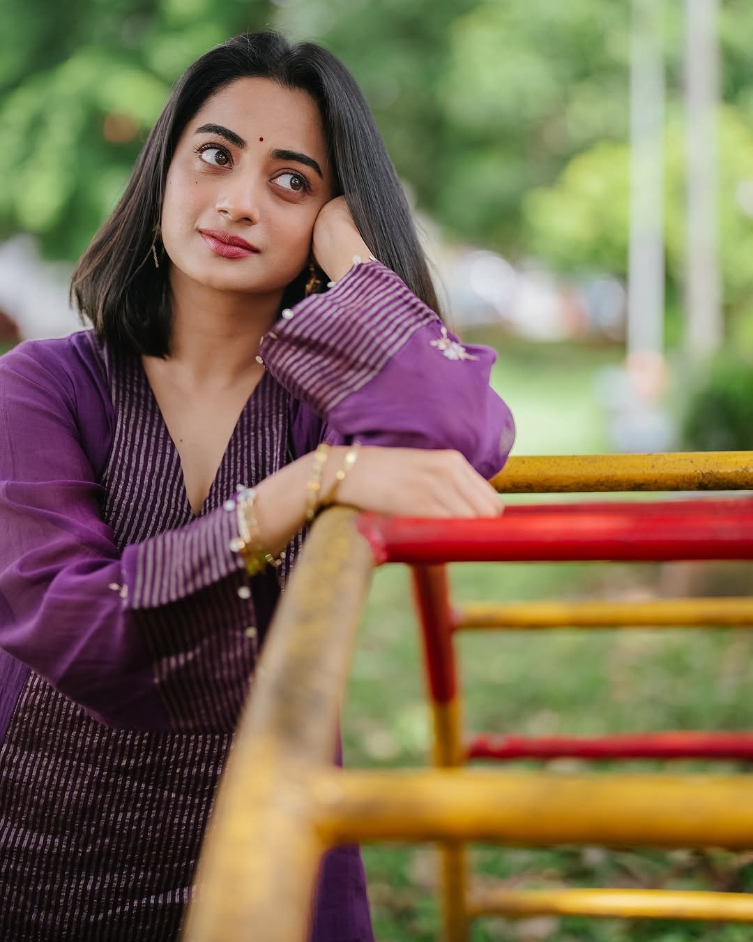 Namitha Pramod purple pleated suit garden bench radiant smile Photos (5)