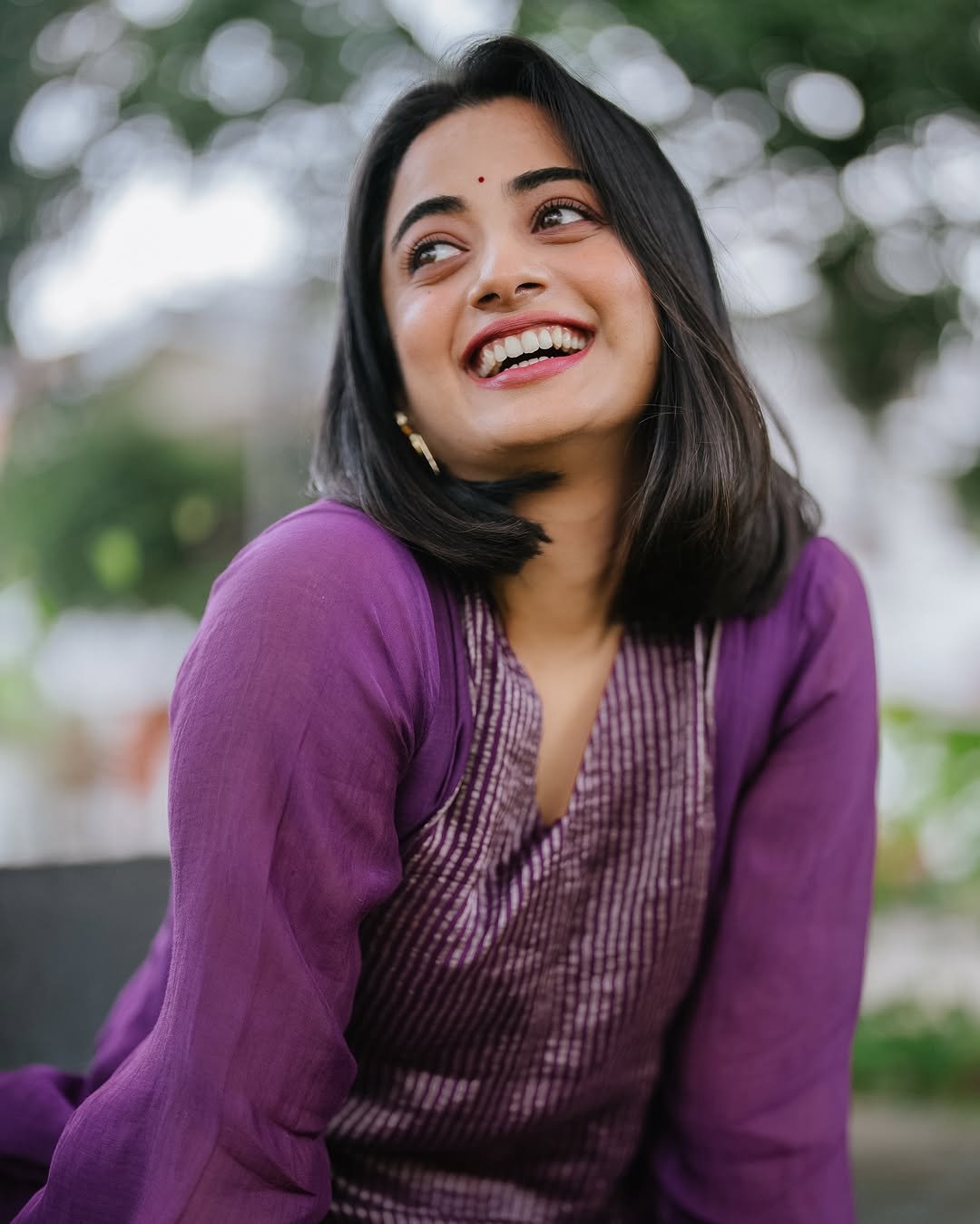 Namitha Pramod purple pleated suit garden bench radiant smile Photos (6)