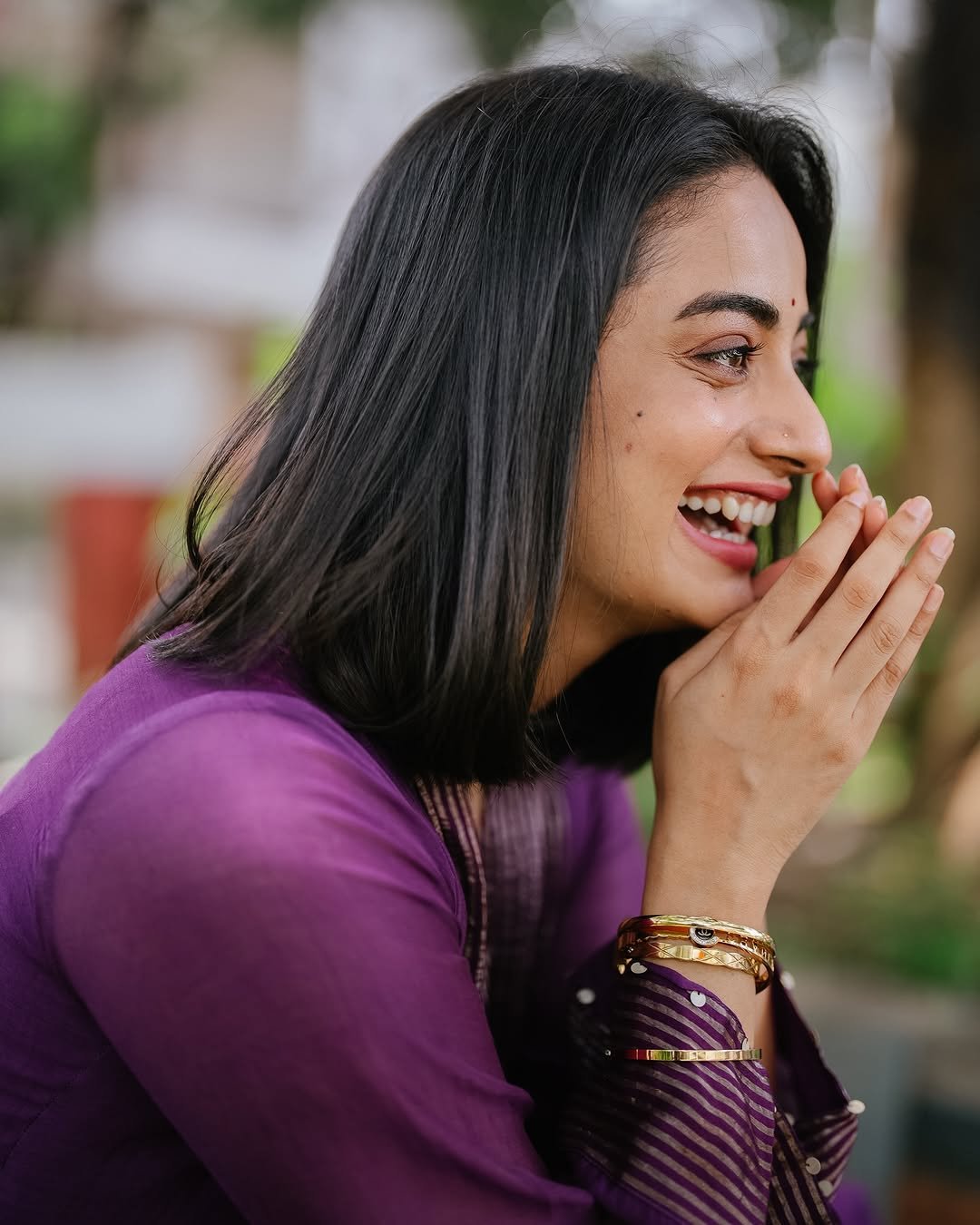 Namitha Pramod purple pleated suit garden bench radiant smile Photos (7)