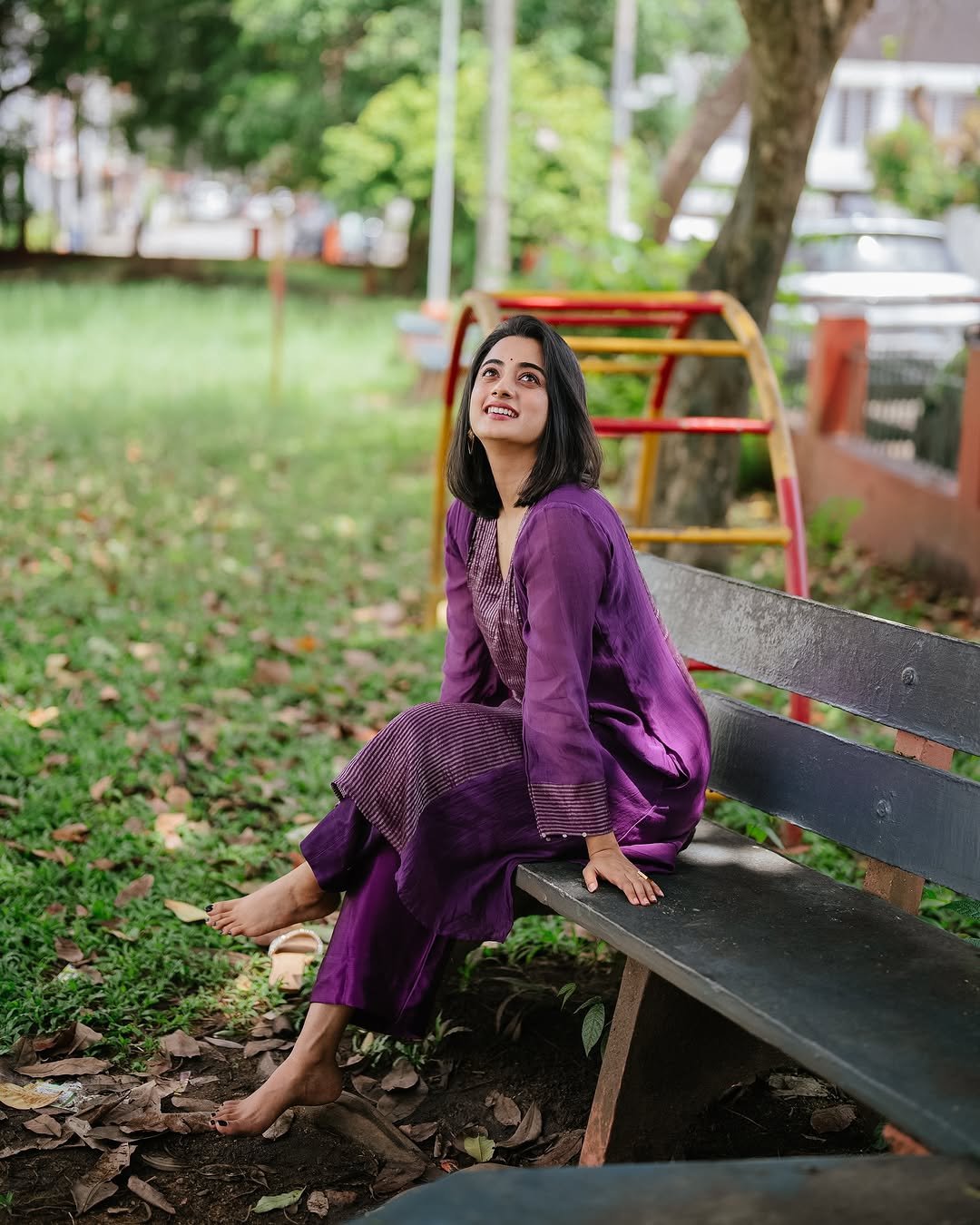 Namitha Pramod purple pleated suit garden bench radiant smile Photos (9)