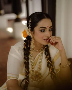 Golden hour sunlight on Namitha Pramod jasmine adorned hair