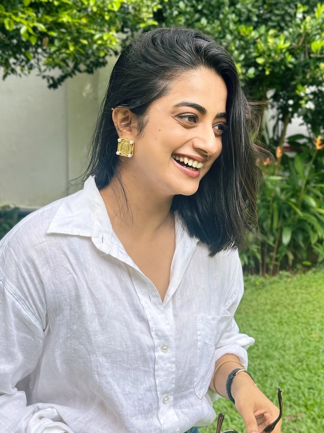 Namitha Pramod white linen shirt garden candid smile Portrait (1)