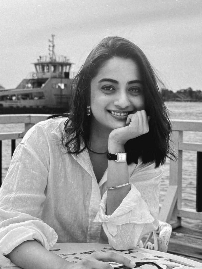 Namitha Pramod candid smile in white linen shirt garden setting